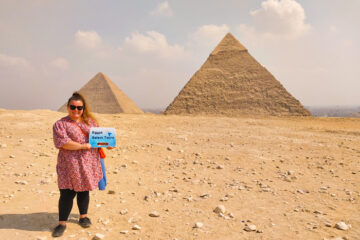 A picture of a girl in front of the pyramids