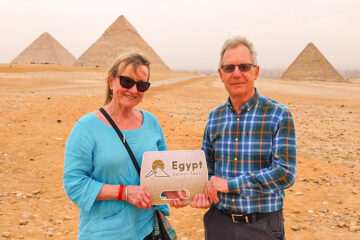 A picture of a couple in front of the Great Pyramids of Giza